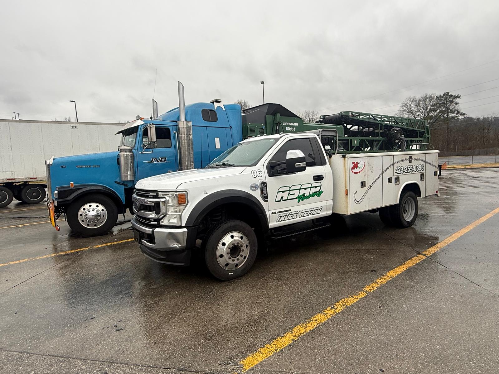ASAP Towing red heavy wrecker towing a semi on the highway, Ringgold GA